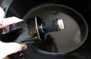 pouring european olive oil into slow cooker 1