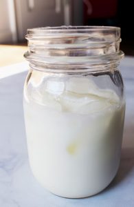 glass mason jar with milk and ice 1