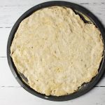 pizza dough pressed into crust pan 1