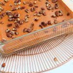 angled view of walnut topped healthy crustless pumpkin pie 1