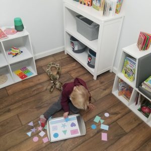 top view of boy playing with shape sorting activity 1