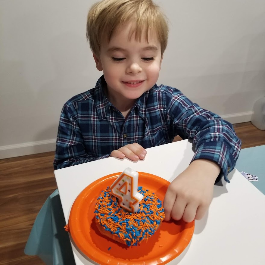 four year old with birthday donut