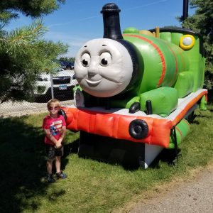 Boy standing with Percy inflatable train