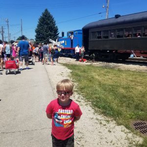 boy in front of Thomas the tank engine.